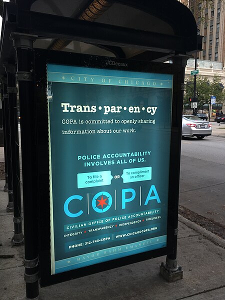 File:Police accountability sign on bus shelter (38102680571).jpg