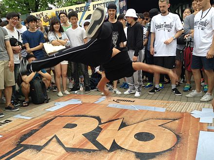 A breakdancer does an air-flare in a cypher at R16 Korea 2014