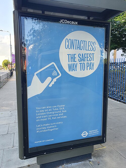 A Transport for London bus stop advertisement recommending contactless payment as safe during the COVID-19 pandemic.