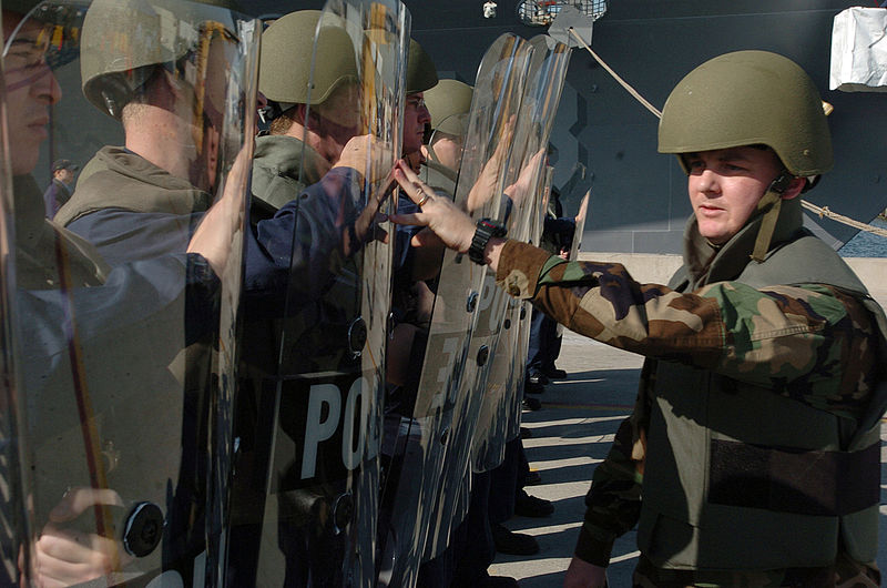 File:US Navy 060111-N-9866B-012 Master-at-Arms 1st Class Edward Henriksen tests the strength of a riot control team consisting of duty section Sailors.jpg