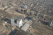 Luchtfoto met zowel een oud, toen nog te slopen, deel uit 1989 als een nieuwbouwdeel uit 2013, gezien vanuit het zuidwesten; 9 maart 2014.