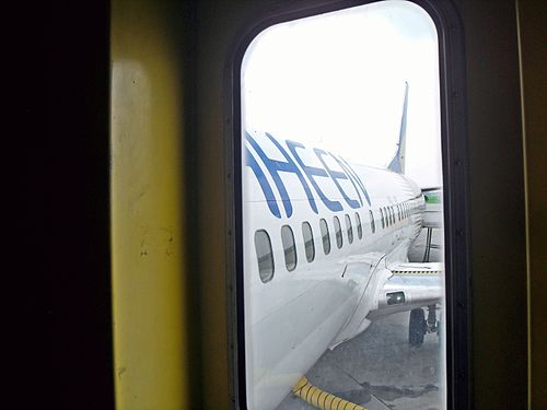 View of aeroplane windows from the jet bridge window at Allama Iqbal International Airport