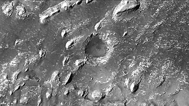 Crommelin crater showing layers in buttes and inside a small crater, as seen by CTX camera. Note: this is an enlargement of a previous image of Crommelin crater.