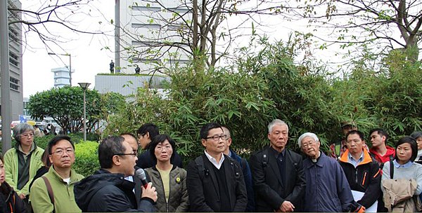 The trio and protesters, including former Roman Catholic Cardinal Joseph Zen (4th from right), surrender to police (3 December 2014)