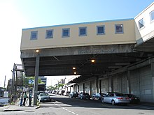 The Joe Desimone Bridge once connected the North Arcade to the now-demolished Municipal Market Building. It now contains craft-priority daystalls. 06 Pike Place Market Desimone bridge with vendors inside on Western Avenue facing north.jpg