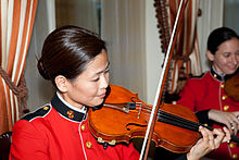 Violinist from the Marine Band performing during a reception at the residence of the Commandant of the Marine Corps on July 19, 2013 A member of the U.S. Marine Corps Band performs during the Evening Parade reception at the Home of the Commandants prior to the parade at Marine Barracks Washington in Washington, D.C., July 19, 2013 130719-M-MM982-024.jpg