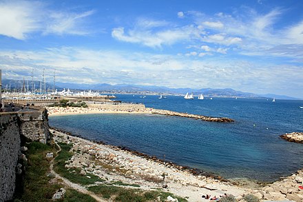 Antibes' beach and port seen from city walls. In the background, Cagnes and Nice.