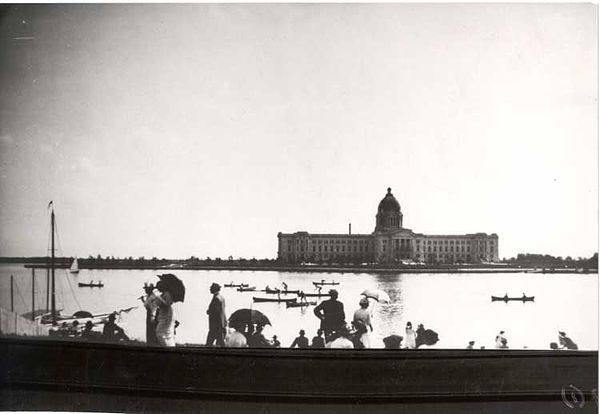 People enjoying a boat race on Wascana Lake north of the Legislative Building circa 1910.