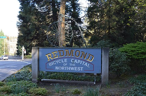 Welcome sign on Redmond Way reading "Redmond: Bicycle capital of the northwest" and featuring a pennyfarthing bicycle atop the written portion of the sign