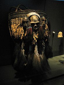 A ceremonial basket of the Konyak tribe with a skull and two human heads carved from wood. This basket is a status symbol. Ceremonial basket Konyak Naga.jpg