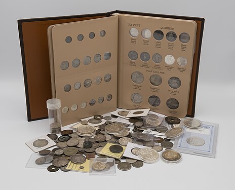 A coin collection, featuring coins loose and in various storage mediums.