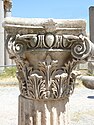 Composite capital whose design includes acanthus leaf, and volute motifs