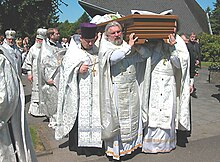 An Orthodox priest being carried to the cemetery on the shoulders of his brother priests. Die Beerdigung Priesters Alexander Penkow.jpg