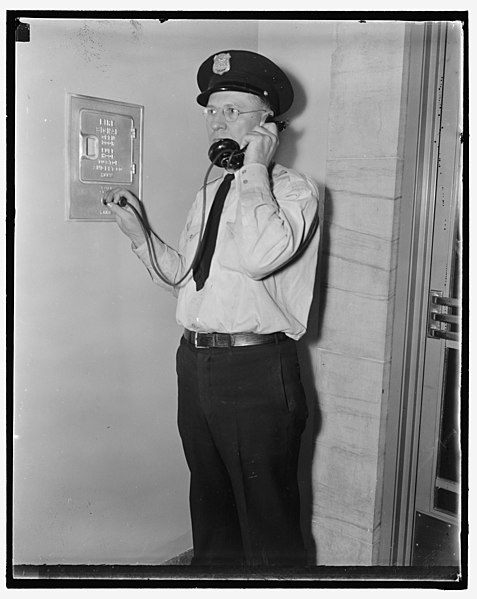 File:F.B.I. guard reports in. Washington, D.C., Aug 4. Officer Ray D. Buckingham using a plug-in telephone, which every guard carries as part of his regular equipment, reports to headquarters as LCCN2016872113.jpg