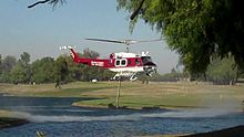 OCFA helicopter extracting water from the lake in the park Fire helicopter extracting water from Carbon Canyon Park lake.jpg