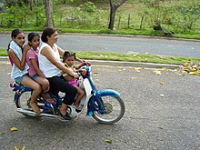 Dominican mother with three daughters rides motorcycle in Jarabacoa. Four Females on One Bike - Jarabacoa - Dominican Republic.jpg