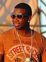 Gucci Mane (pictured), was the first to sign Young Thug Gucci Mane performing at the Williamsburg Waterfront 3 (cropped).jpg