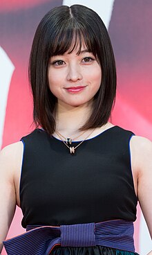 Kanna Hashimoto in sleeveless dress facing camera with arms lowered and hands folded in front of body