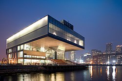 Oblique view of the Institute of Contemporary Art on Boston's waterfront at night with the city in the background.