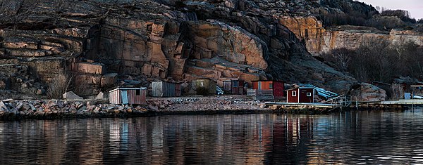 Last light of the day on shacks at the old dock in the abandoned granite quarry in Govik, Lysekil Municipality, Sweden.