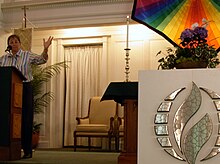 Moderator Nancy Wilson preaching at an MCC church in Minneapolis in 2008. LogoMCC.JPG