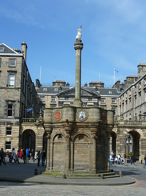The Mercat Cross viewed from within Parliament Square looking across the Royal Mile with the pediment of Edinburgh City Chambers in the background.