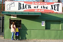 A soccer mom and her child at a refreshment stand at the Metropolitan Oval, a soccer complex in Queens, New York Met Oval snack bar.jpg