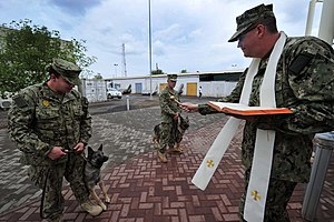 The blessing of a working animal, a military dog. Military working dog blessing 141004-N-RY232-042.jpg