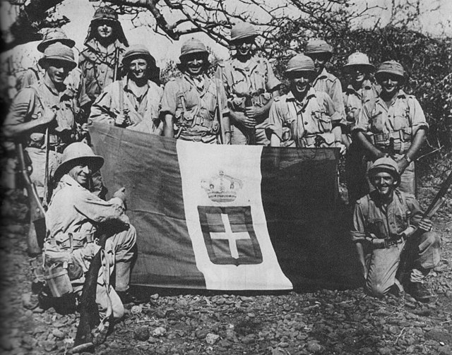 South African soldiers with a captured Italian flag, 1941