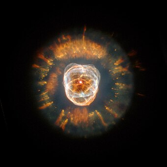 The Eskimo Nebula is illuminated by a white dwarf at its center.