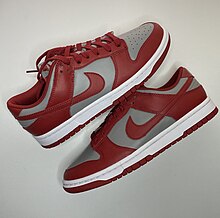 A pair of red and gray Nike Dunk shoes Nike dunk.jpg
