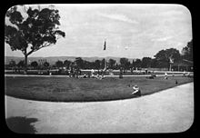 LeFevre Terrace Playground in 1922 showing children playing, shelter shed, swings and dominated by a large gum tree North Adelaide, Glover Playground, 1923.JPG