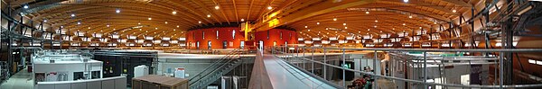 Panoramic view of the inside of the Swiss Light Source. An experiment end-station is visible on the left, the concrete tunnel at the end of the bridge in the middle of the photo houses the electron beam. Panorama sls.jpg