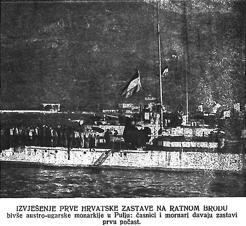 First Croatian flag ever hoisted on a naval ship, Pula, October 31st, 1918, with the crews saluting the flag