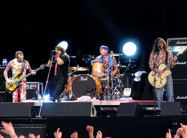 Red Hot Chili Peppers in 2006, showing a quartet lineup for a rock band (from left to right: bassist, lead vocalist, drummer, and guitarist)