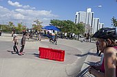 Sam Sneed kickflips over a red barrier at Far Rockaway Skatepark.jpg