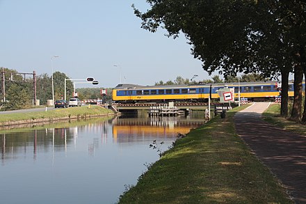 A swing bridge near Meppel, the Netherlands. There is no overhead line on the bridge; the train coasts through with raised pantograph.