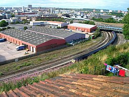 Temple Meads rail station approaches from Richmond Street, edge of Totterdown, with the Bath Road bridge over the rail lines to the right of image, the Fowlers motorcycle store ('L' shaped building) and modern industrial units in foreground Temple Meads approach from Totterdown.jpg