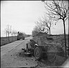 Sherman tanks passing a disabled German armoured car