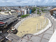 Roald Dahl Plass. The Mermaid Quay shopping complex is to the left. The Oval Basin, Cardiff Bay - geograph.org.uk - 6839069.jpg