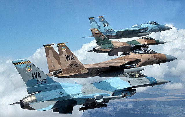 A flight of Aggressor F-15 Eagles and F-16 Fighting Falcons fly in formation over the Nevada Test and Training Range