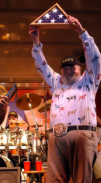 File:US Navy 030911-C-0368R-003 Country musician Charlie Daniels dons a Navy ballcap and waves the National Ensign presented to him by Command Master Chief Michael Tsikours of Recruit Training Command.jpg