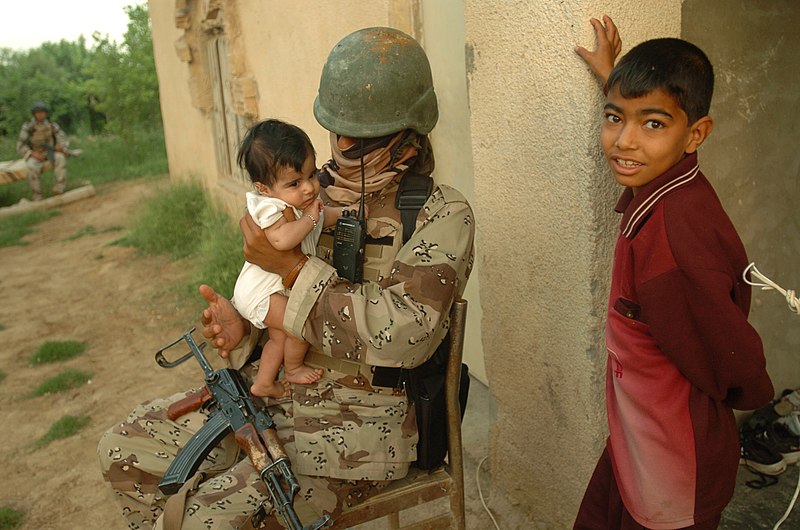 File:US Navy 060506-N-8252B-066 Operation Iraqi Freedom An Iraqi army soldier holds a little girl as her brother stands close by during a patrol in Abu Shemsi.jpg