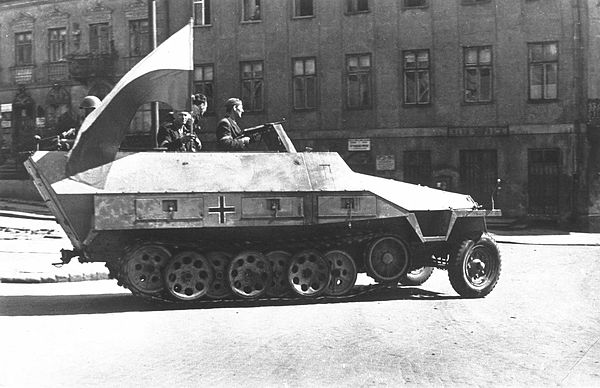 A captured German Sd.Kfz. 251 from the 5th SS Panzer Division, being used by the 8th "Krybar" Regiment. Furthest right; commander Adam Dewicz "Grey Wo