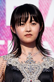 head and shoulders image of Itō in black and silver dress, facing camera