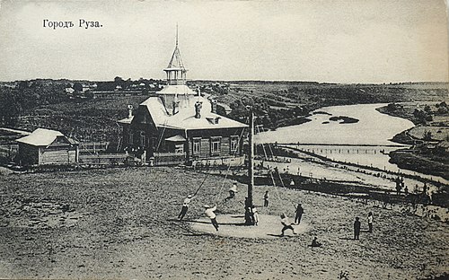 Local region museum in Zemstvo library on the banks of the Ruza river. In the foreground — giant-stride (attraction) on the Gorodok (the site of the ancient Ruza Kremlin). Ruza city (postcard ~1911-1912), Moscow Governorate, Russian Empire