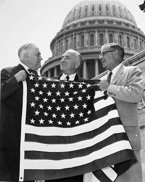 Bob Bartlett and Ernest Gruening, Alaska's inaugural U.S. Senators, hold the 49 star U.S. Flag after the admission of Alaska as the 49th state.