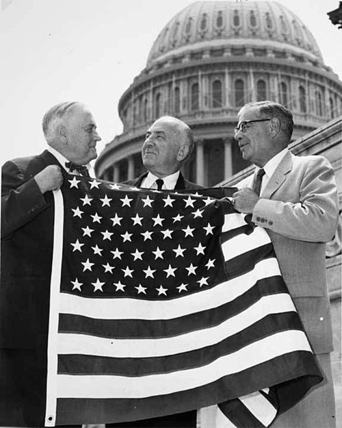 Bob Bartlett and Ernest Gruening hold the 49 star U.S. Flag after the admission of Alaska as the 49th state.