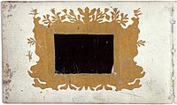 p118 - Unknown contributor - Cut art - Small piece of mica on black linen in a cut-out cartouche