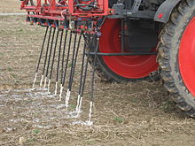 Application of urine on a field near Bonn, Germany, by means of flexible hose close to the soil Application of urine (4461921719).jpg